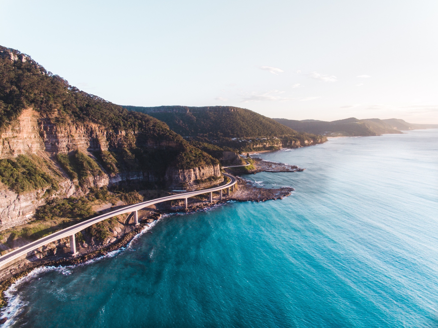 Beautiful coastal road along NSW's east coast, representing our service areas across Newcastle, Hunter, Central Coast and Sydney regions